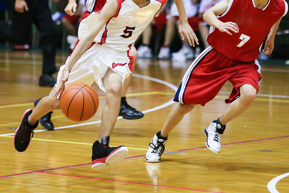 men playing basketball on a court