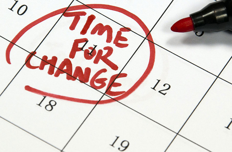 Close up of calendar with date circled in red and note saying "Time for change"