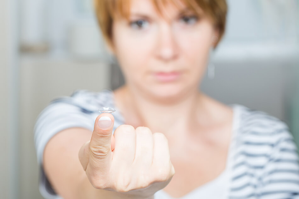 girl with contact lens on finger