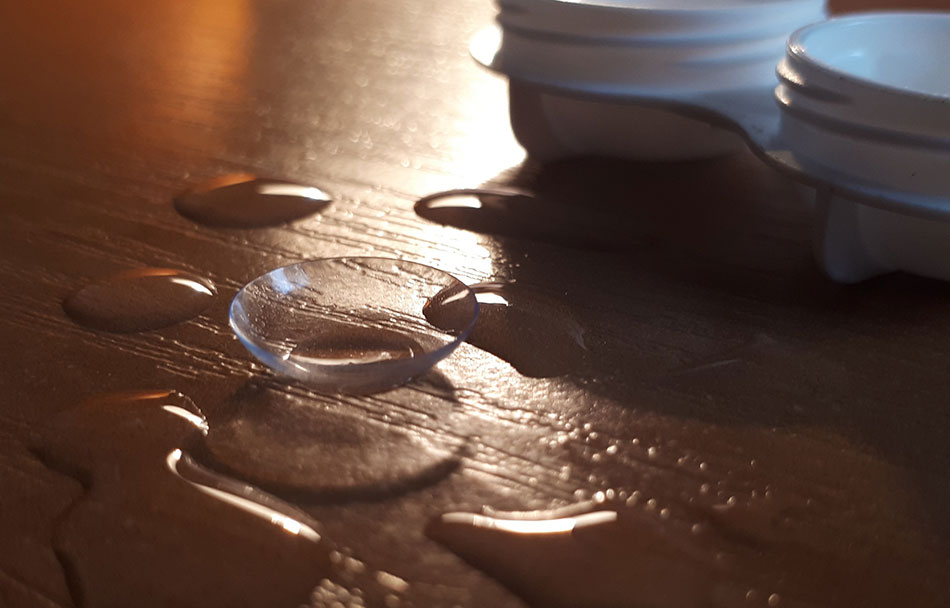 contact lens on table in drops of water