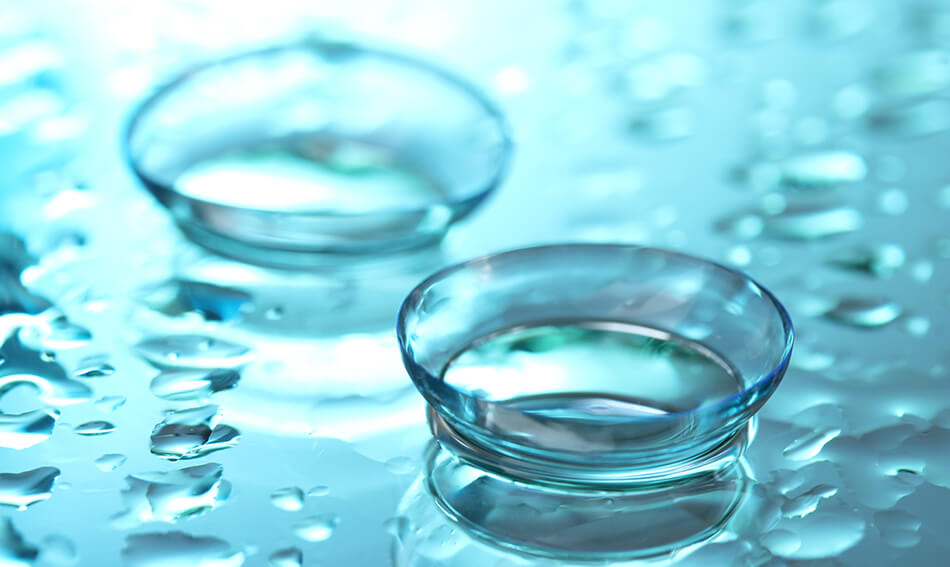 contact lenses with drops on blue background