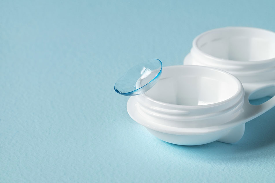contact on rim of open contact case blue background