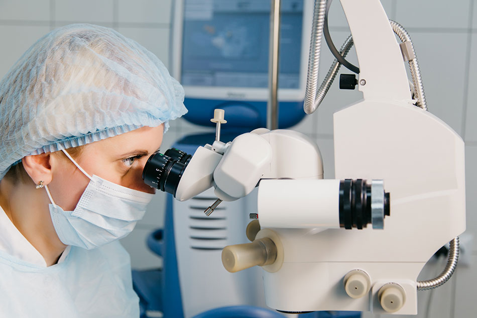 eye surgeon in mask using LASIK equipment