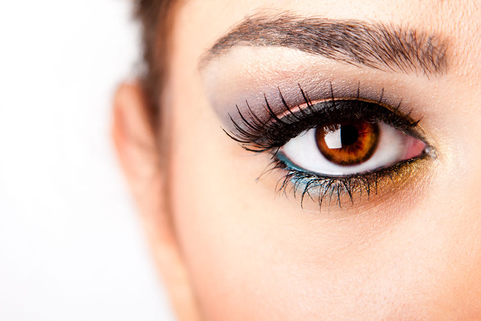 woman wearing blue and gray eyeshadow and brown color contacts