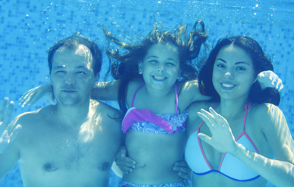 Happy family swimming with contacts