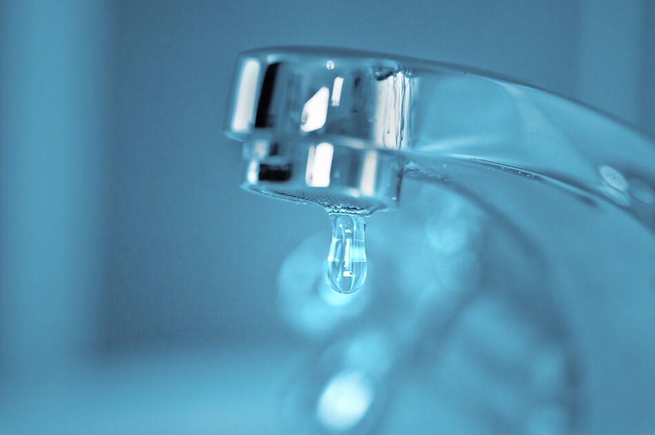 water drop falling from bathroom faucet