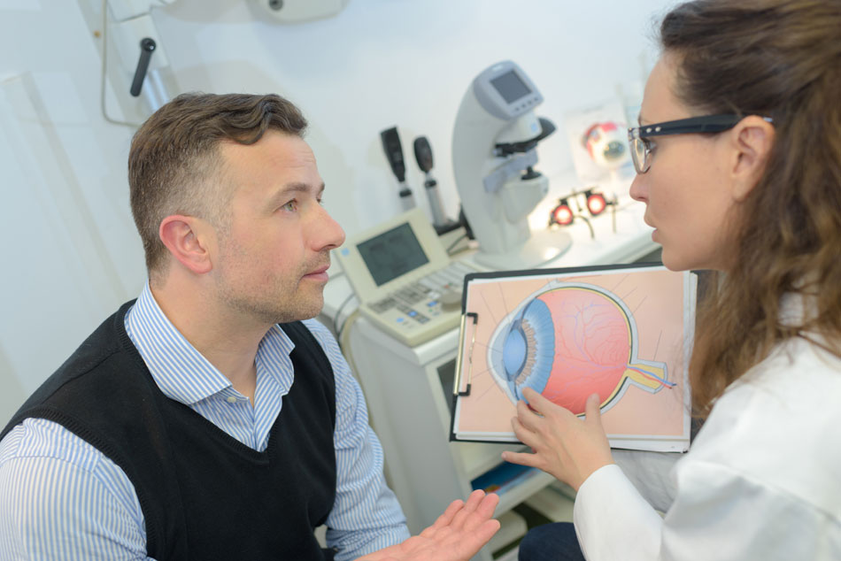 Female eye doctor discussing problem with male patient