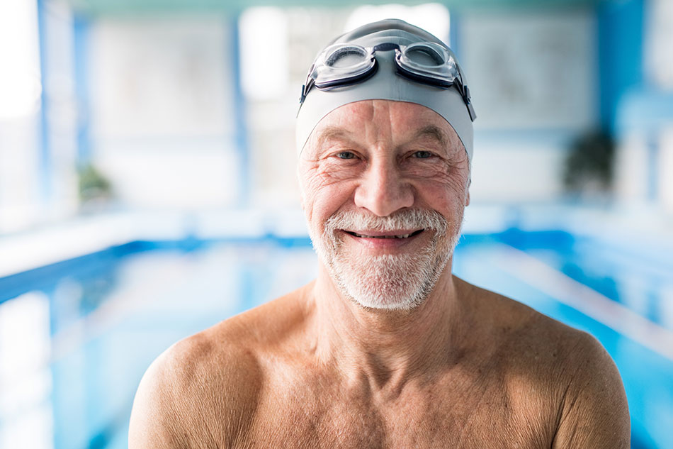 Senior man happy to go swimming with contacts and goggles