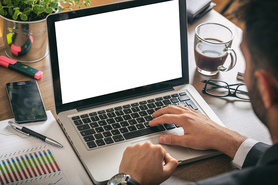 man working on laptop at desk