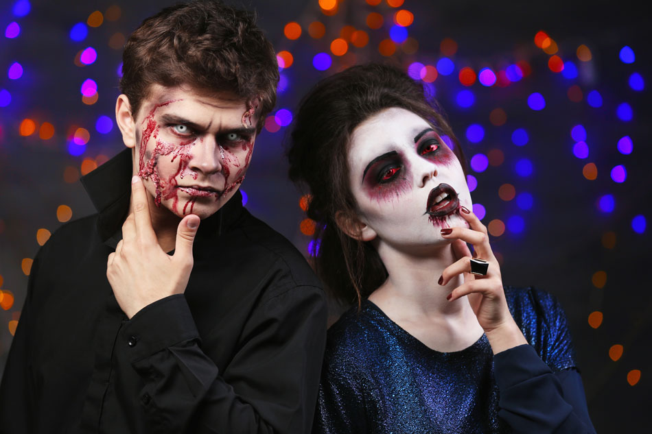 man and woman wearing zombie costumes and color contacts