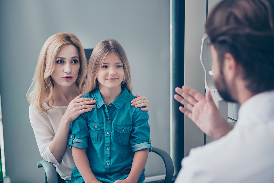 Mom and daughter having consultation with eye doctor