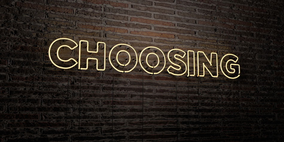 Neon sign saying “choosing” on brick wall