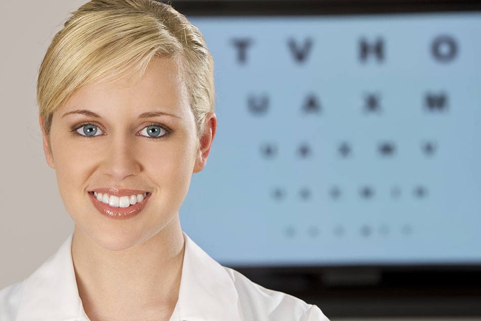 Welcoming female optometrist in front of eye chart
