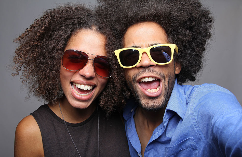 smiling man and woman wearing contact lenses and sunglasses