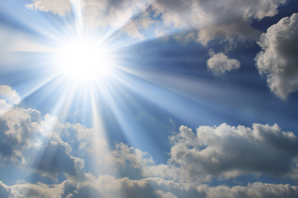 sun with rays shining through clouds and a blue sky