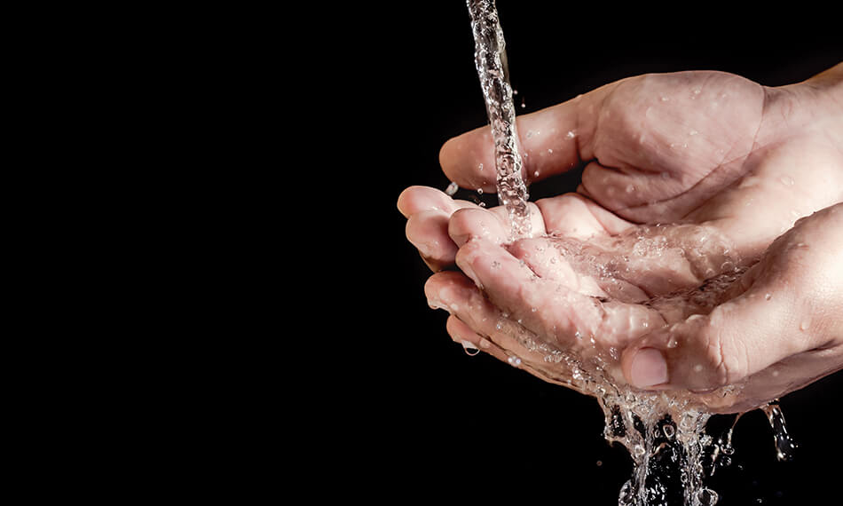 tap water flowing into two cupped hands