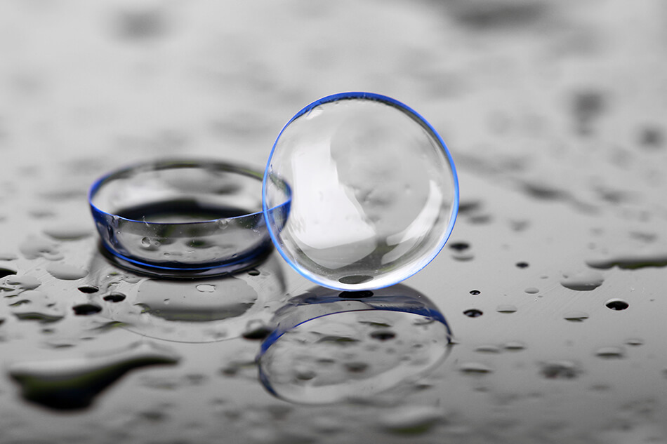 contact lenses for sports with water drops on gray background