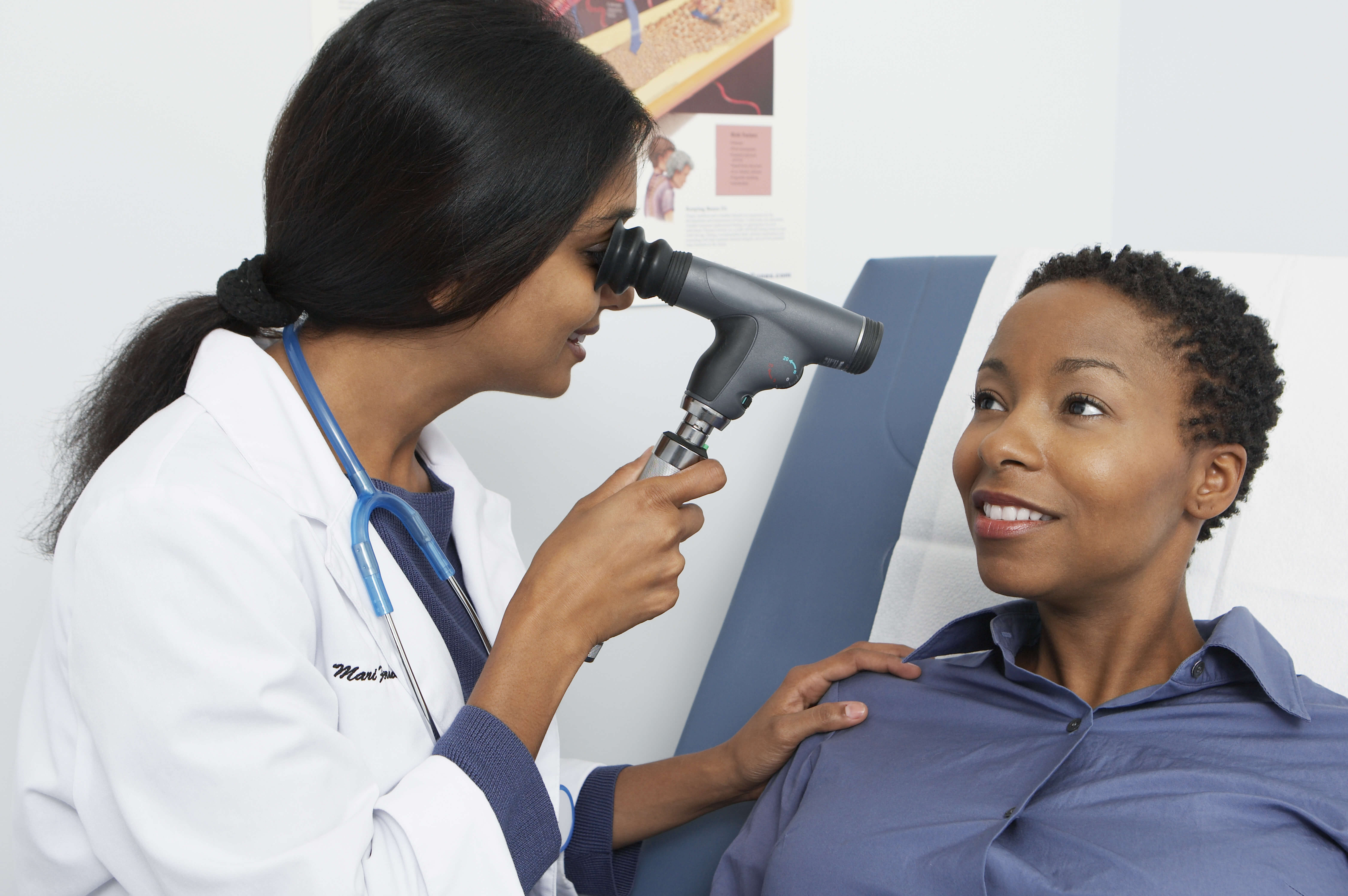 woman at optometrist’s office, getting eye exam and trial contact lenses