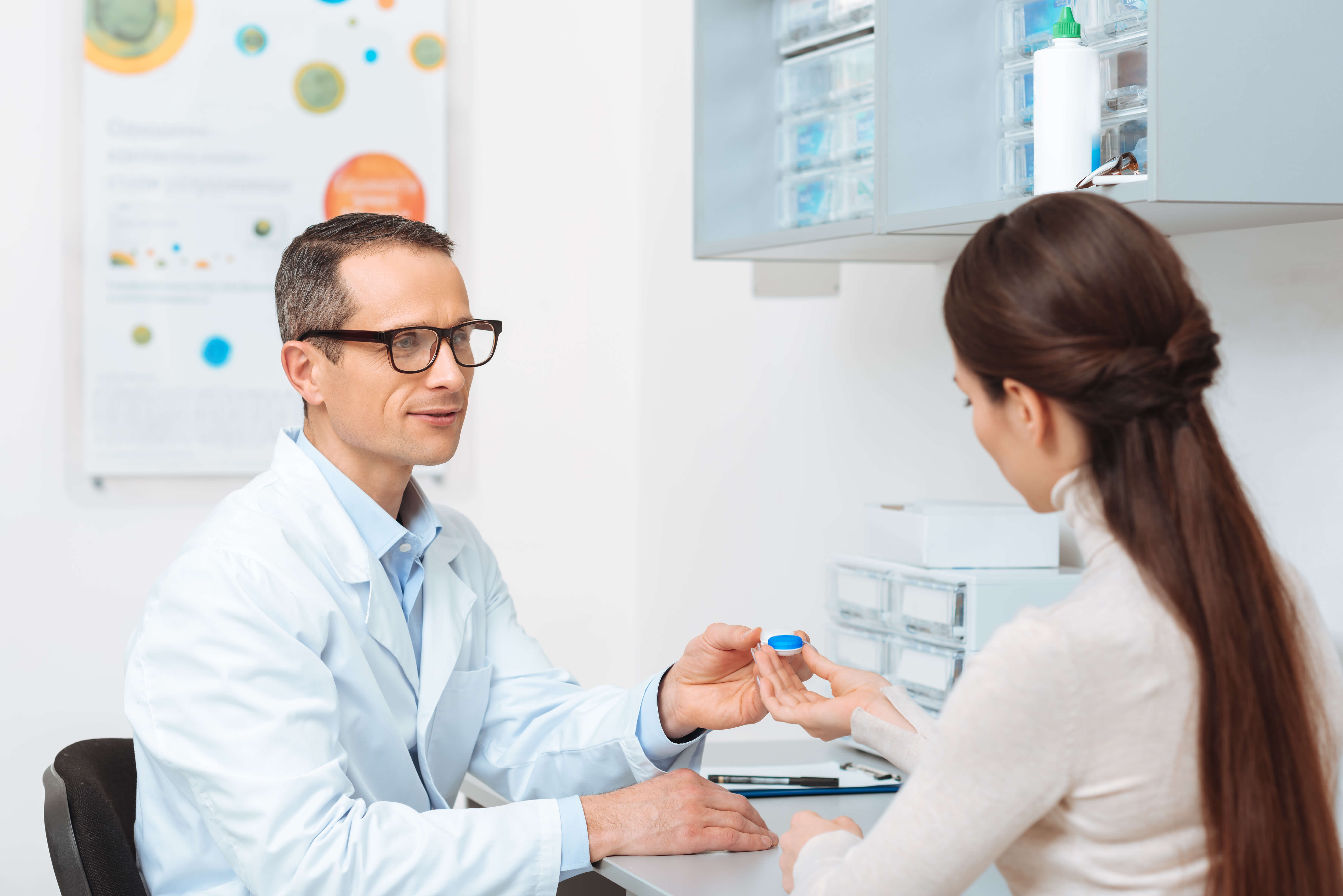 woman getting trial contact lenses from her optometrist