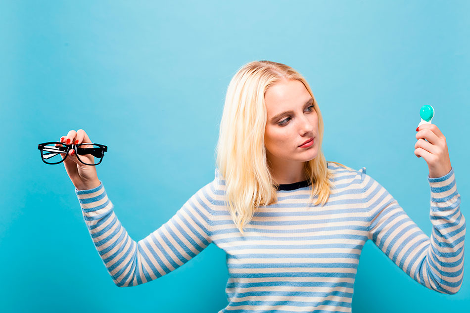 Woman considering glasses or contact lenses