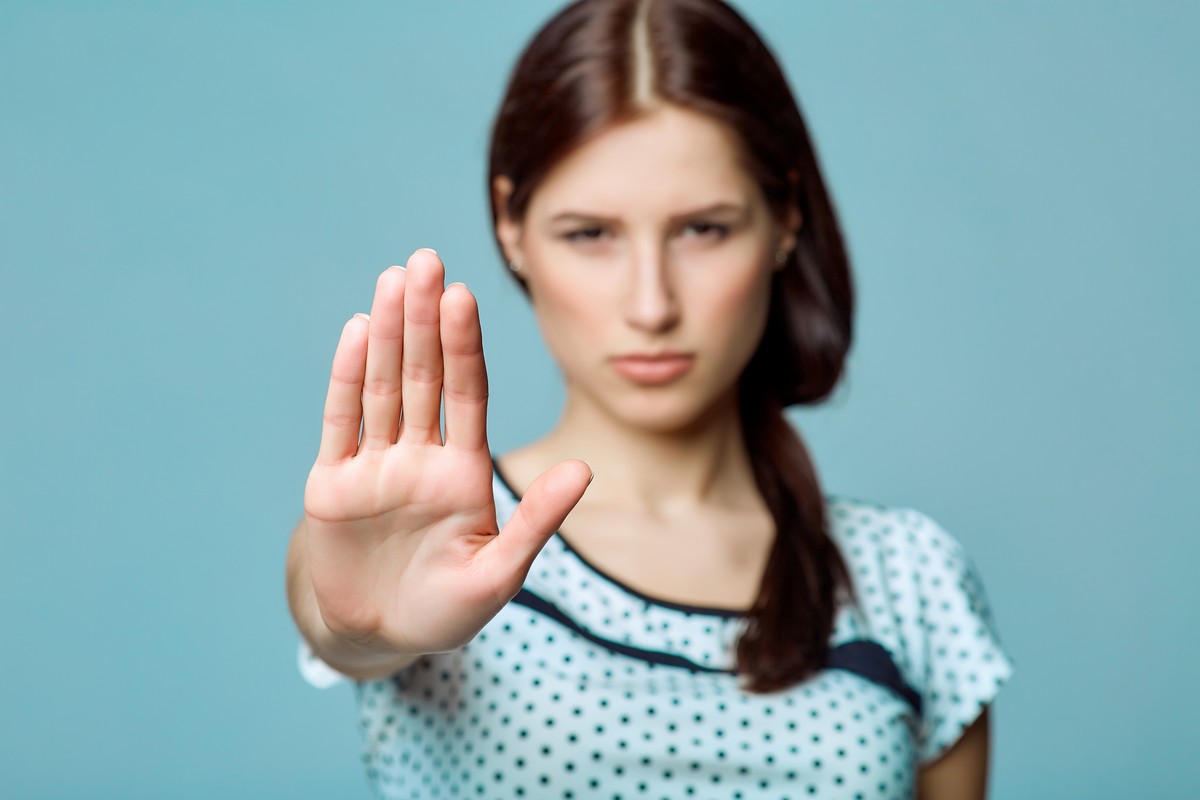 woman with hand outstretched showing stop