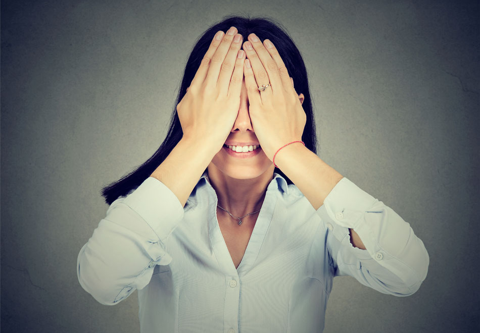 woman with the palms of her hands over her eyes