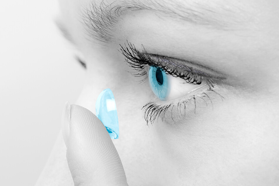 Close-up of woman inserting contact lense