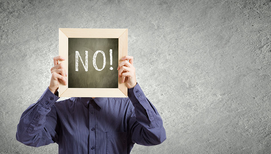 woman with no on chalkboard in front of face