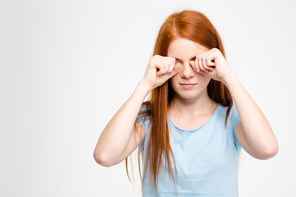 Young girl rubbing her eyes