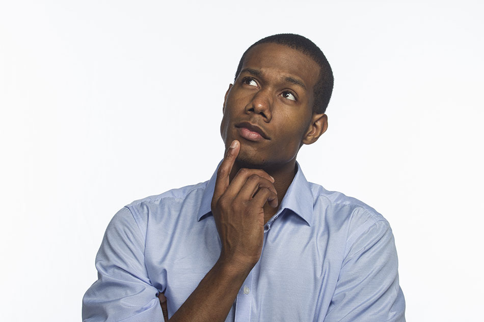 Young man thinking about daily vs. monthly contacts