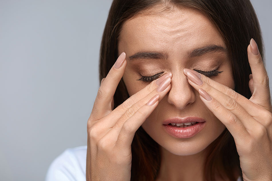 young woman touching painful eyes